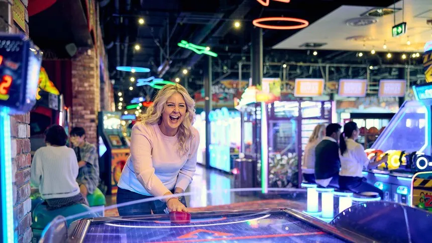Having Fun Playing Air Hockey At Archie Brothers Christchurch.